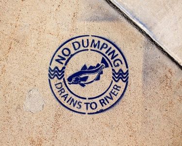no dumping drains to river sign