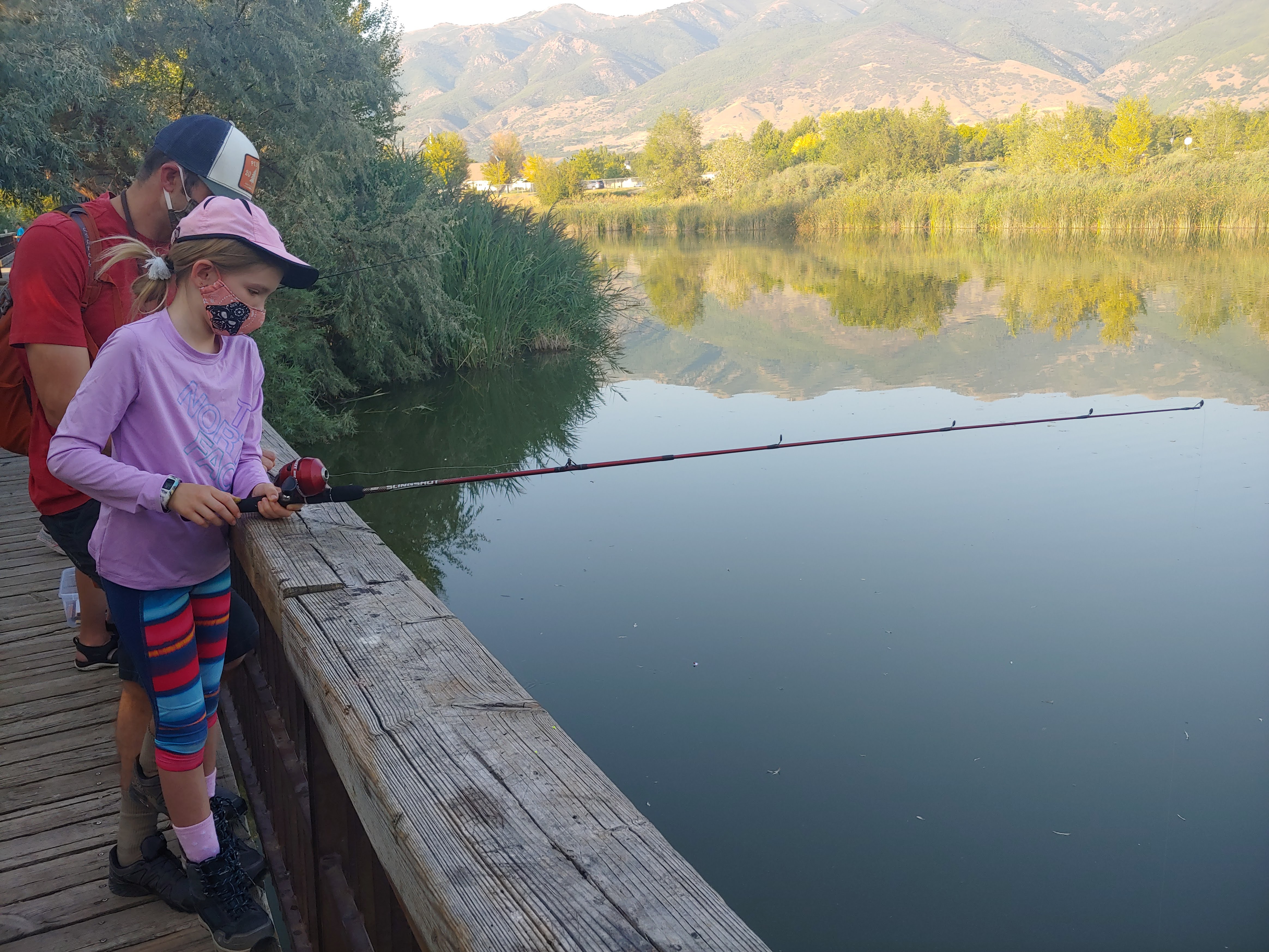 Youth fishing off of boardwalk at Kaysville Ponds