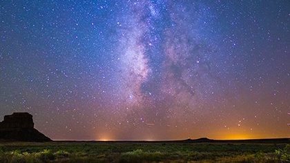 Nighttime sky over a desert landscape