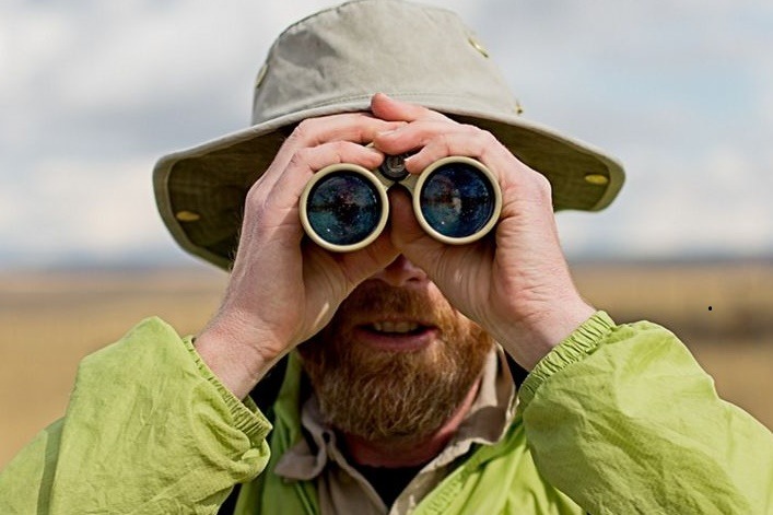 A person looking through binoculars