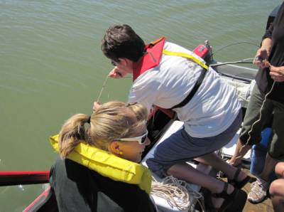 volunteer measuring from a boat