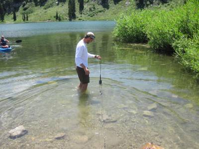 volunteer measuring in shallow water