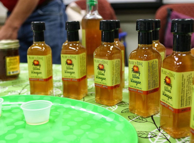 Bottles of honey wine vinegar sitting at a table