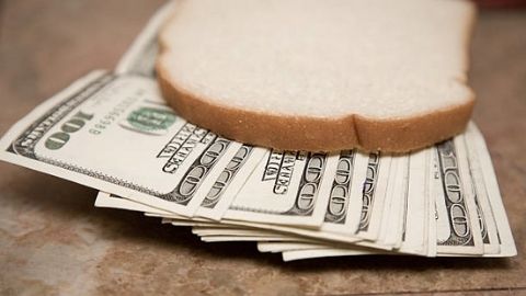 Slice of bread on top of money