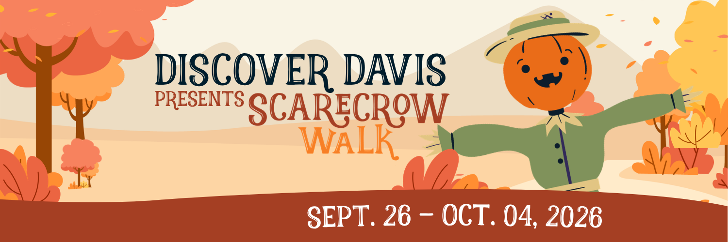 Illustrated banner with a smiling jack-o'-lantern-headed scarecrow in a green coat and straw hat, mountains and autumn trees in the background. Text reads "Discover Davis Presents Scarecrow Walk, Sept. 26 – Oct. 04, 2026.