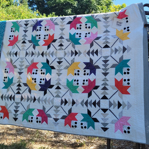 Tulip pattern quilt displayed in garden