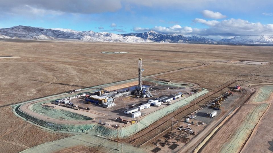 Energy station within an empty stretch of land surrounded by mountains. 