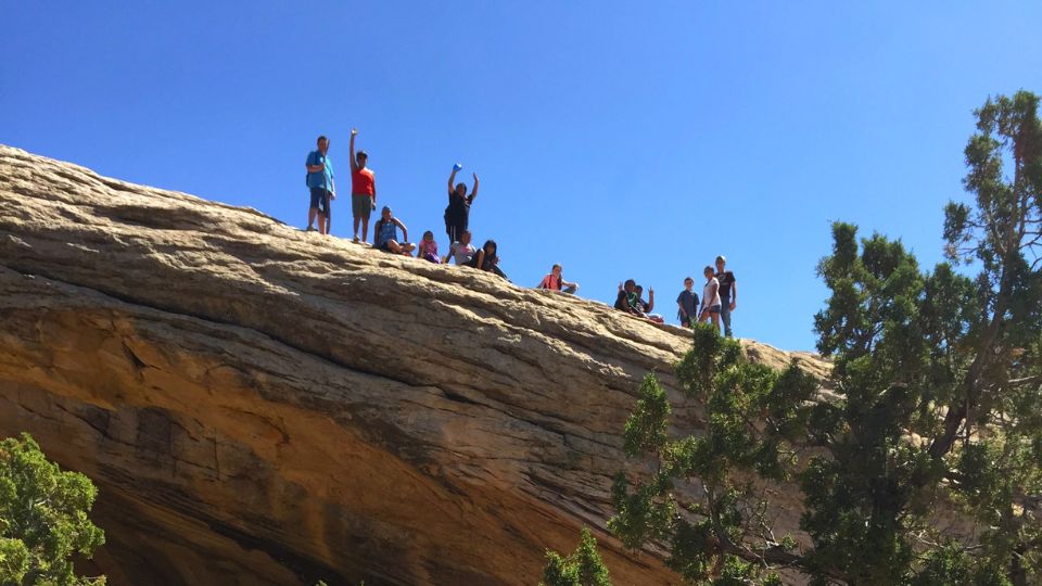 group of people standing on rock