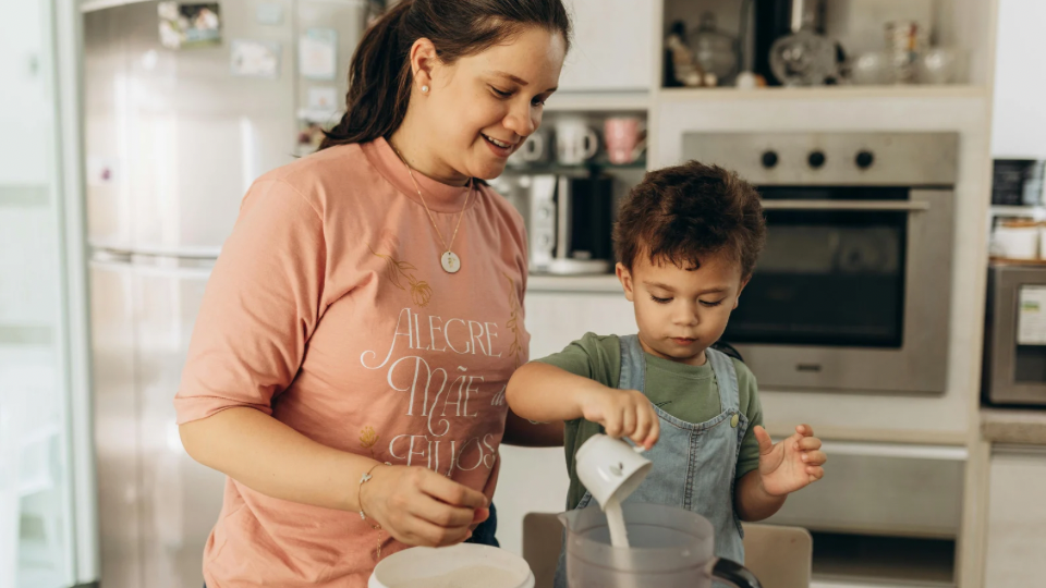Little boy helping his mom cook