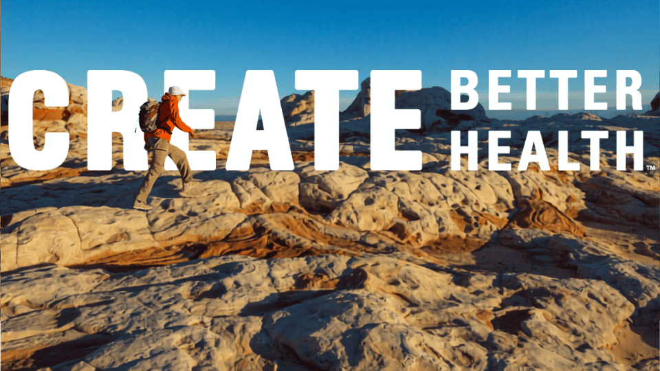 Create Better Health Summer Challenge man hiking in Utah mountains with Create Better Health logo in white letters