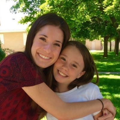 Mentor side hugging mentee