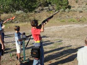 Youth aiming gun safely at range