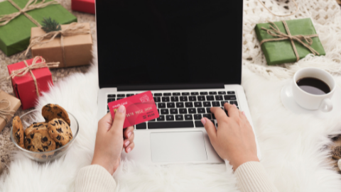 gifts surrounding laptop with credit card