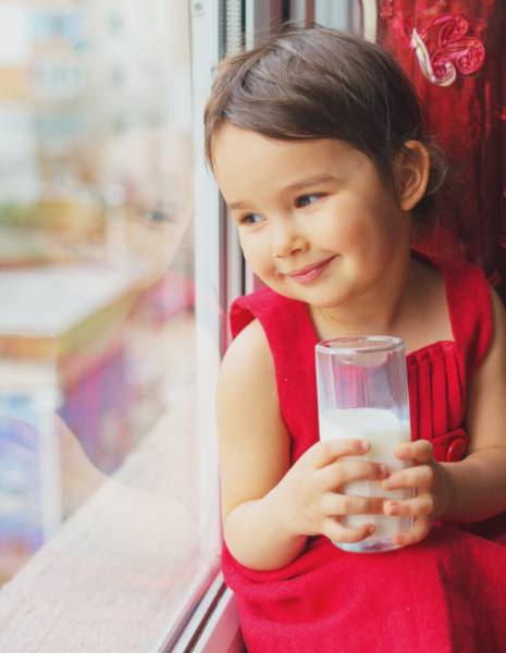 A child enjoying a glass of milk