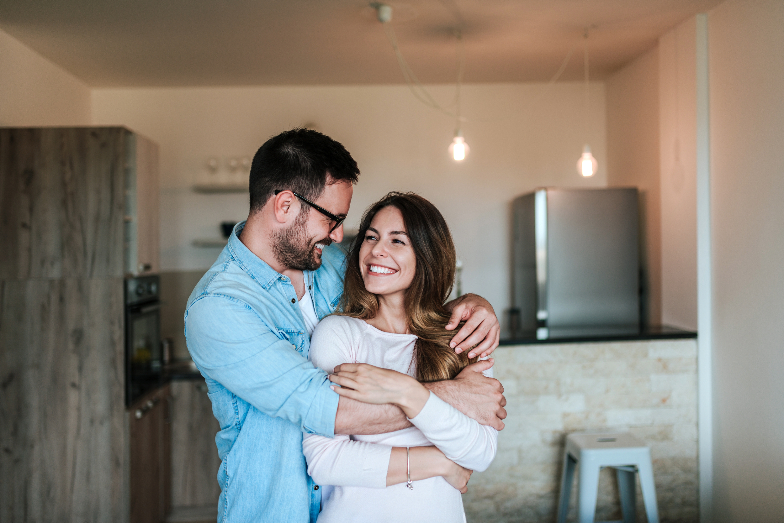 couple hugging each other in the kitchen