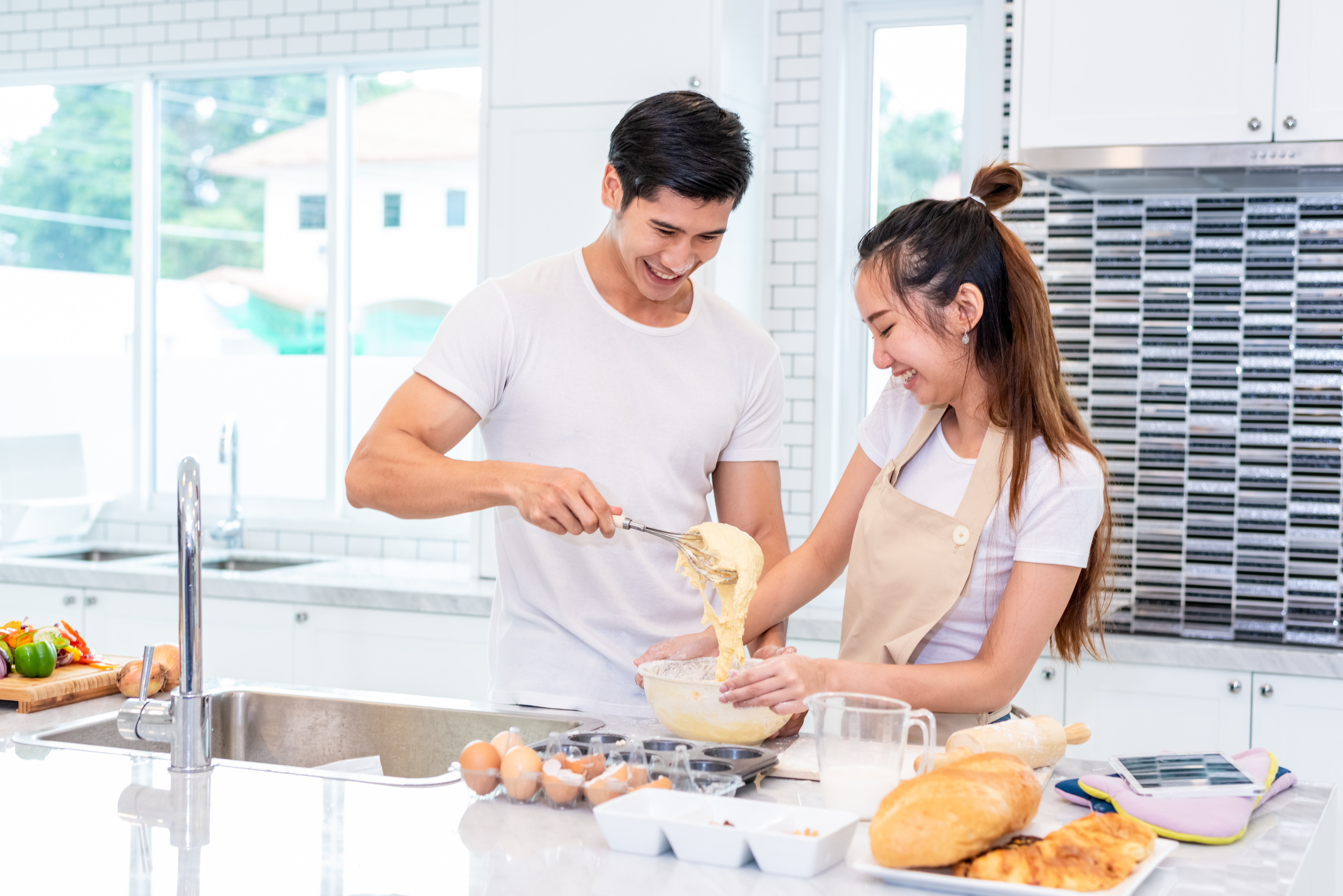 couple baking together in the kitchen
