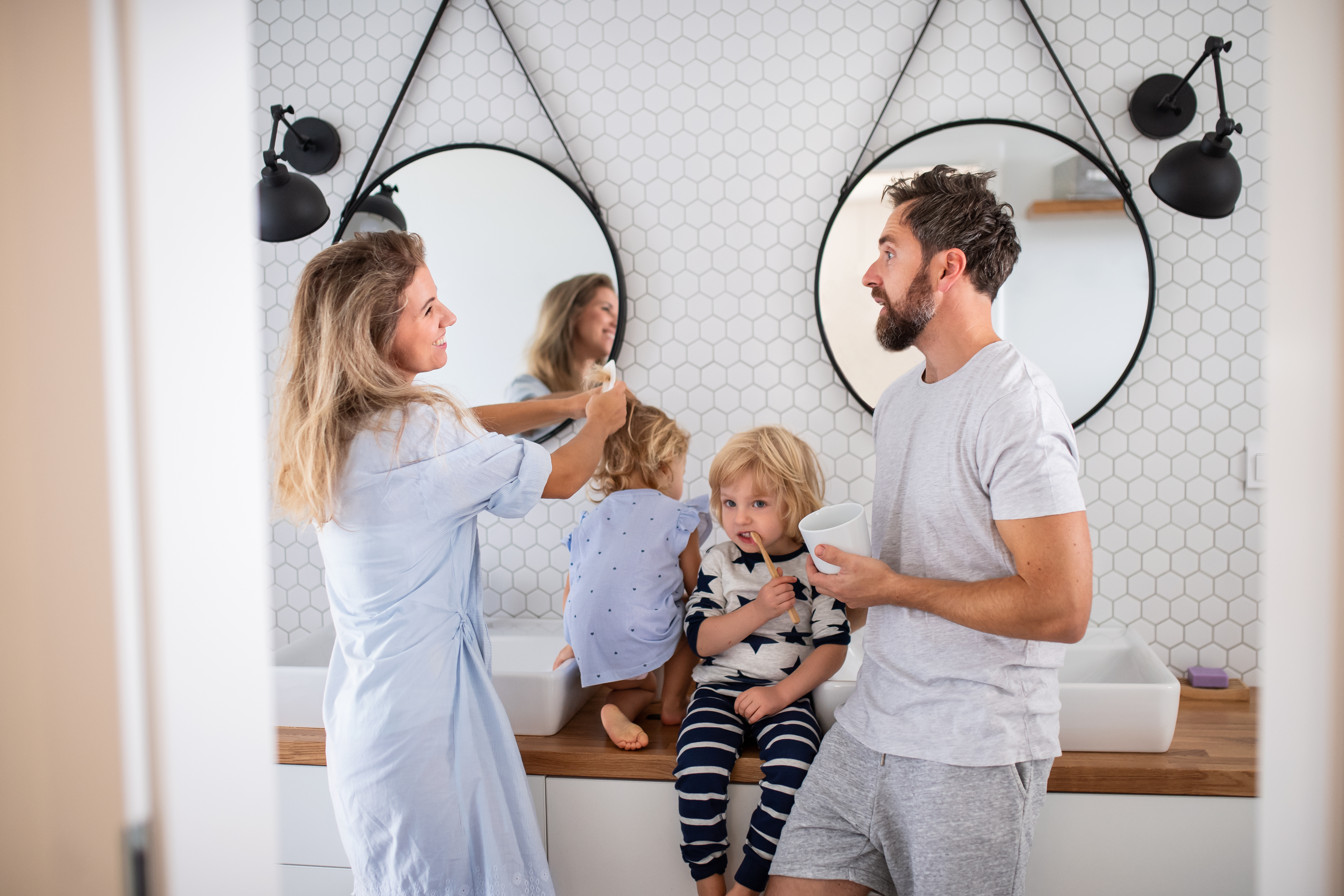 family getting ready for bed brushing their hair and brushing teeth