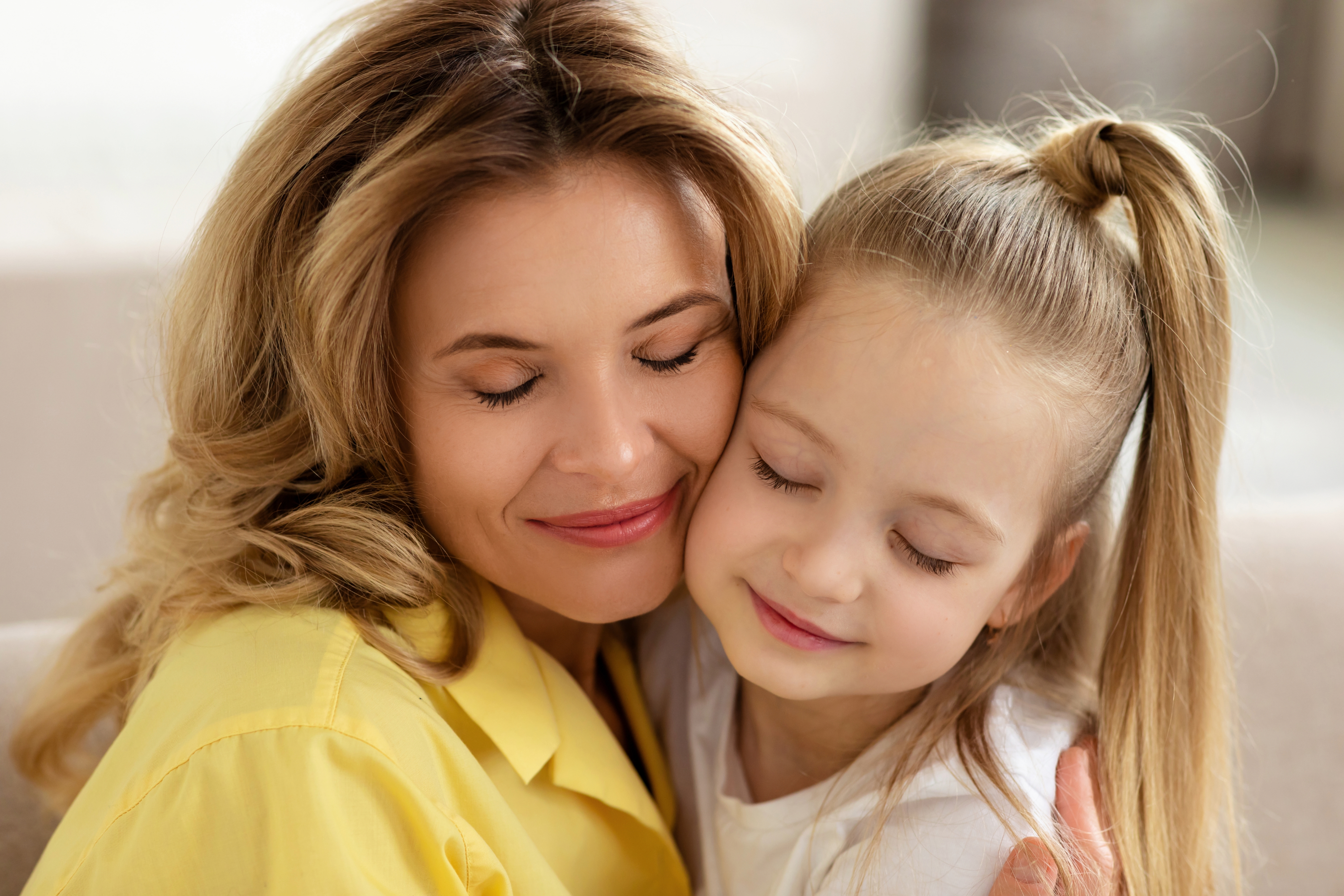 mother hugging her child on the couch