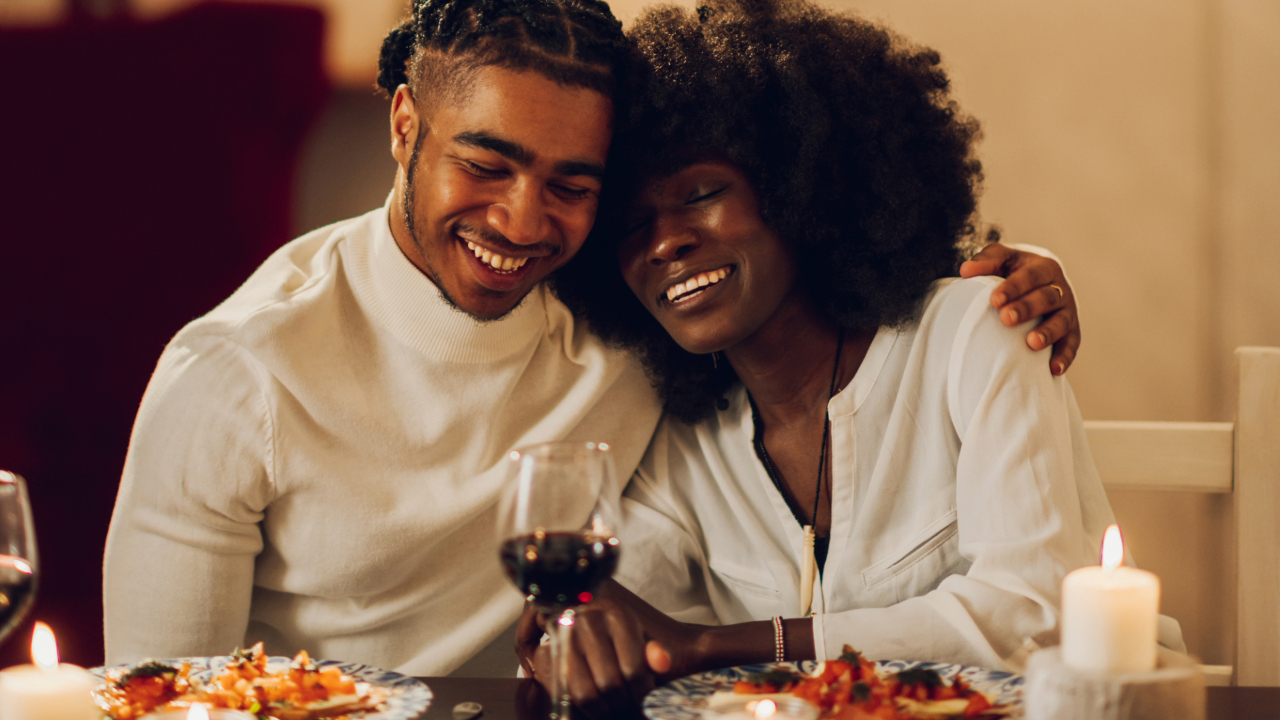 couple hugging while having dinner at a restaurant