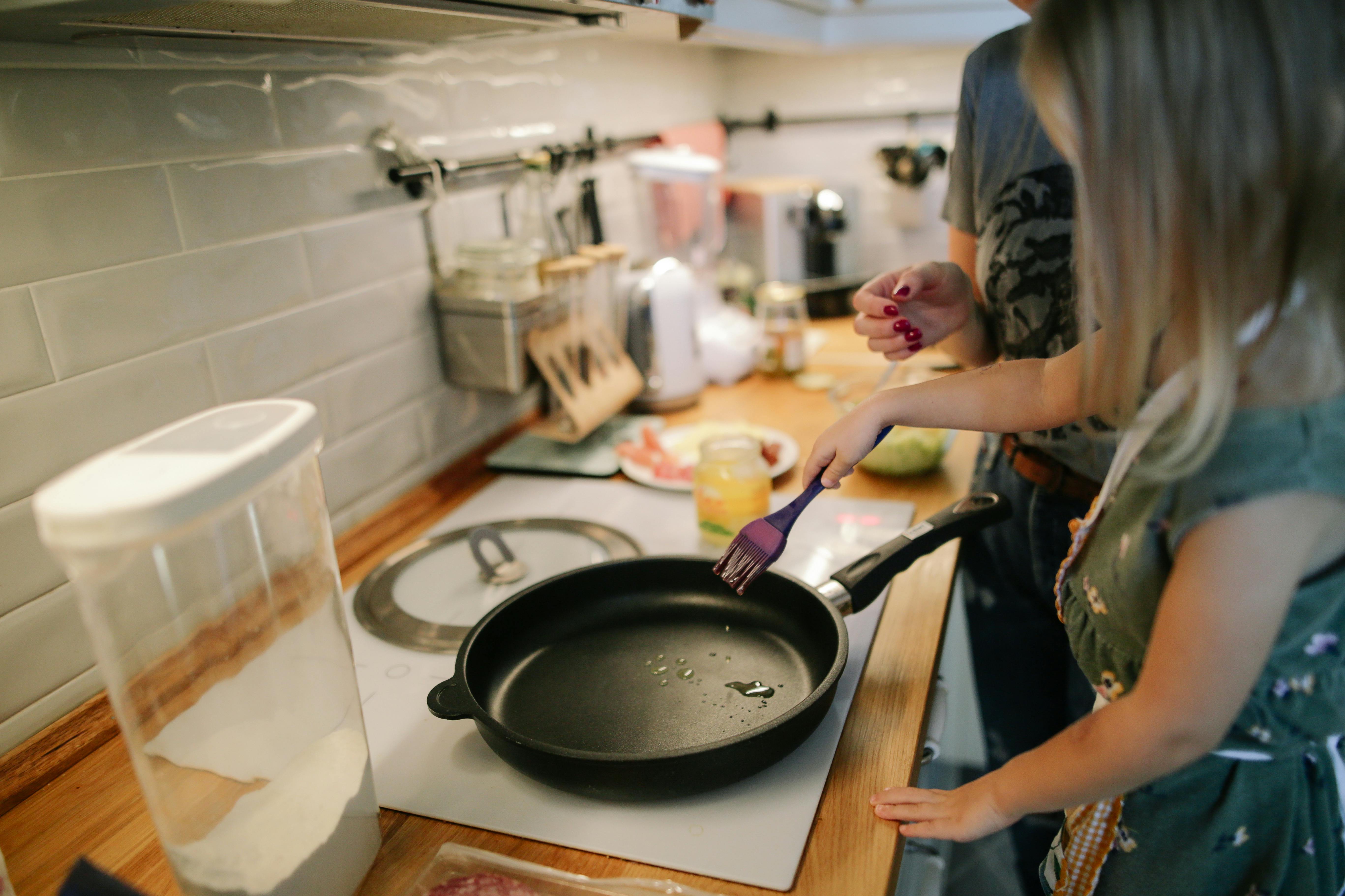 Couple preparing a cast iron pan to cook together