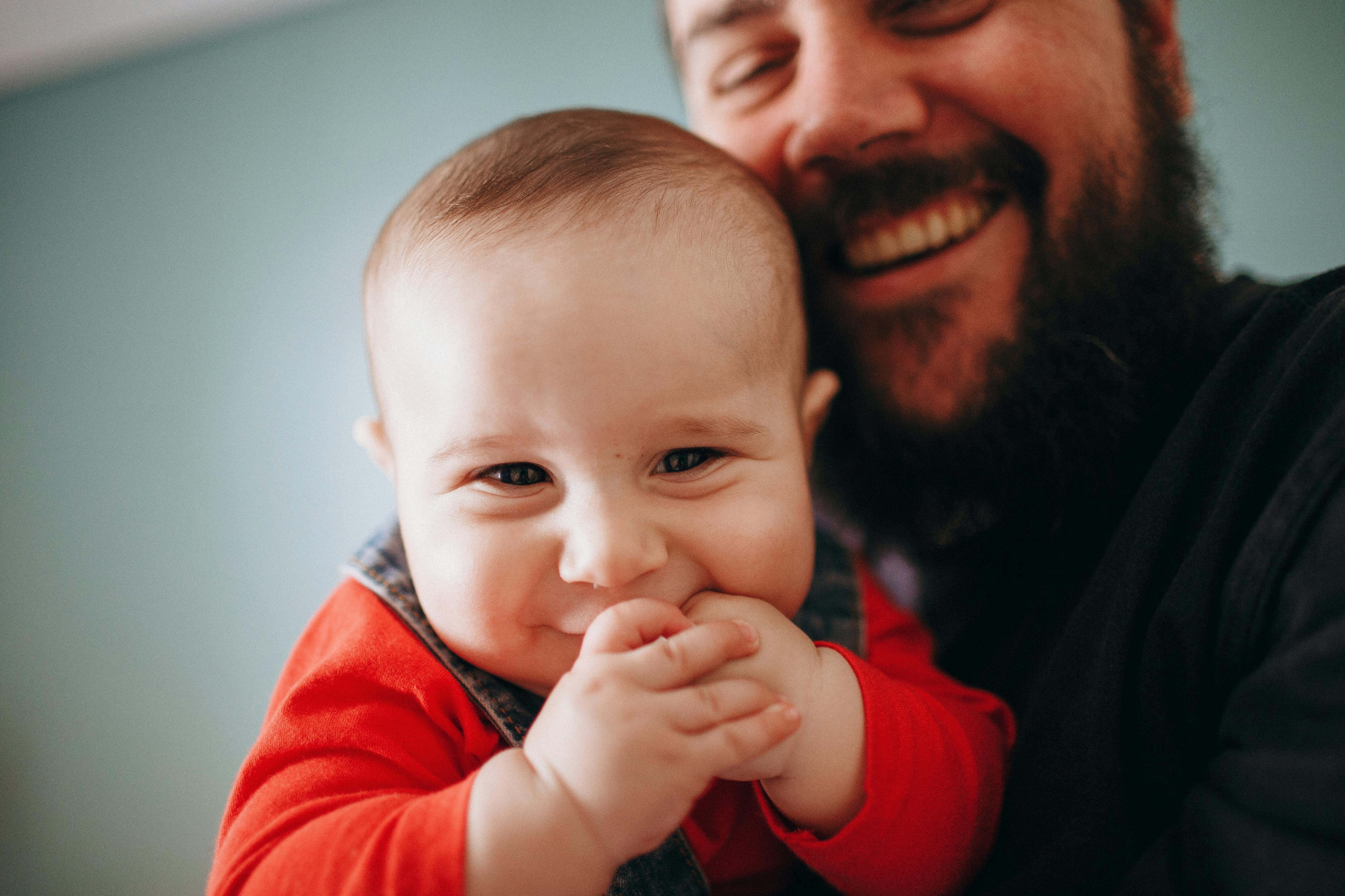 father and son both looking into the camera and smiling