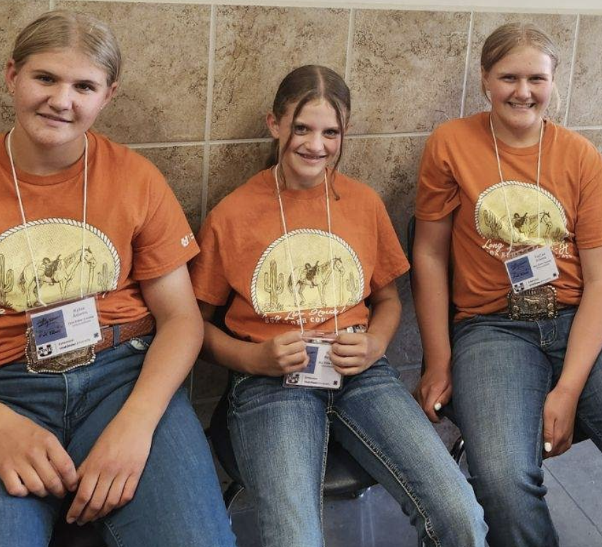 three girls in orange shirts 