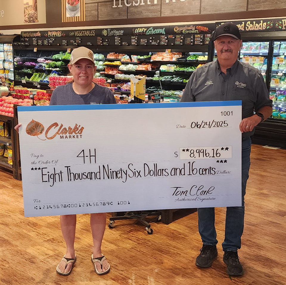 Clark's and 4-H representatives holding an oversized check