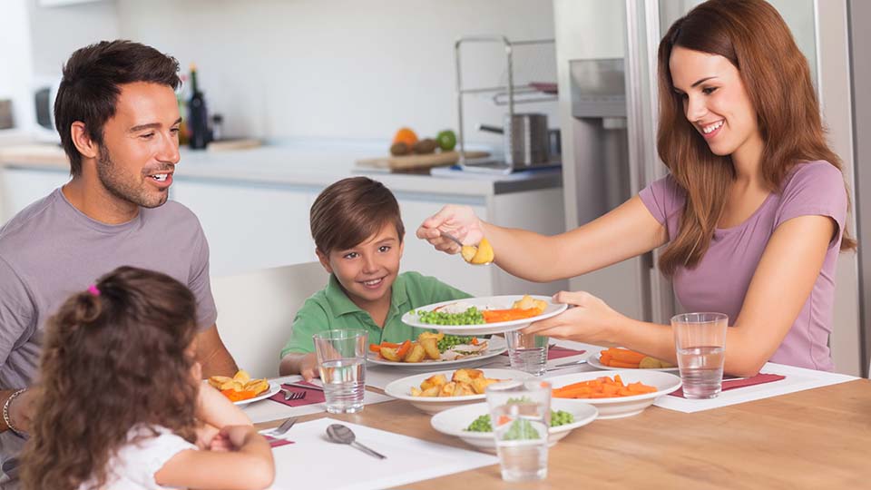 Family enjoying a meal together at a table.