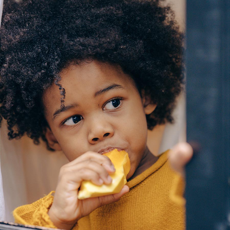 Boy eating mango