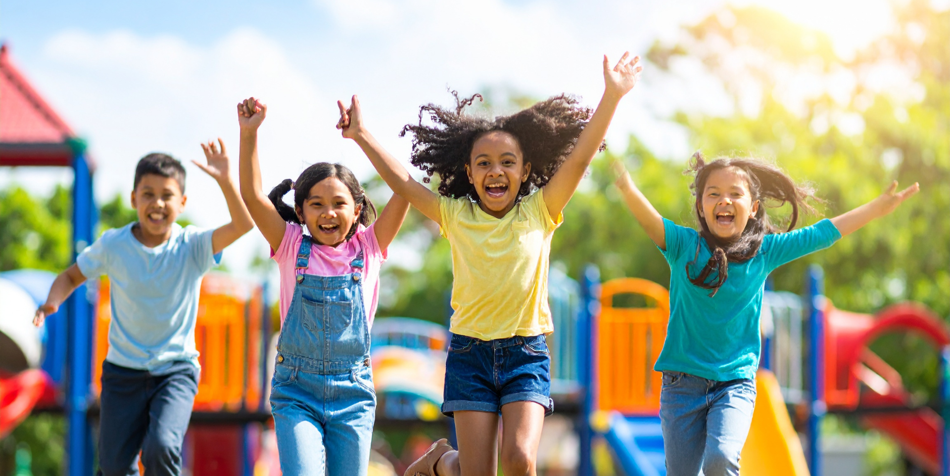 Kids jumping and playing on outdoor playground equipment