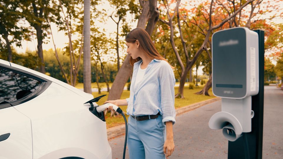 A women charging her electic car.