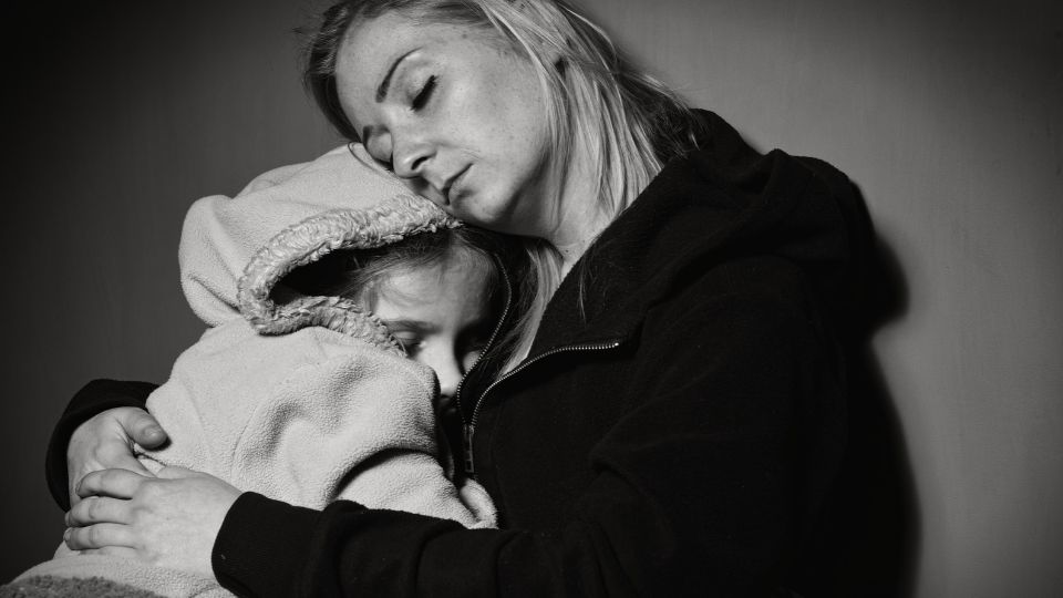 A women sitting and holding a child.