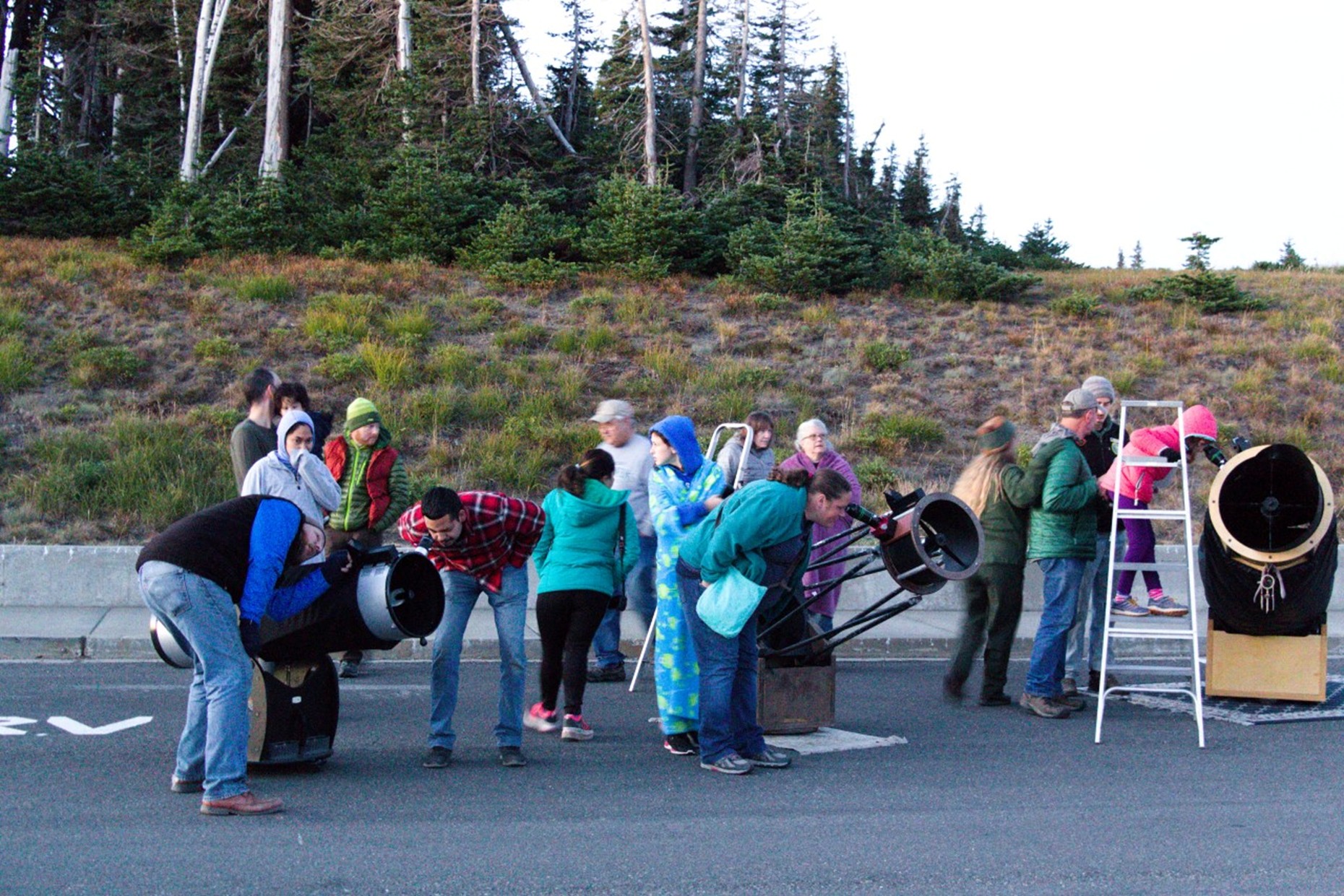 Visitors gather around telescopes during an astronomy outreach program at Hurricane Ridge in Olympic National Park.