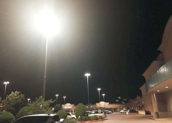 Photo of parking lot with glaring lights from poles