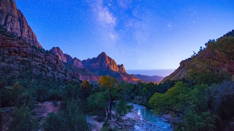 valley with colorful night sky