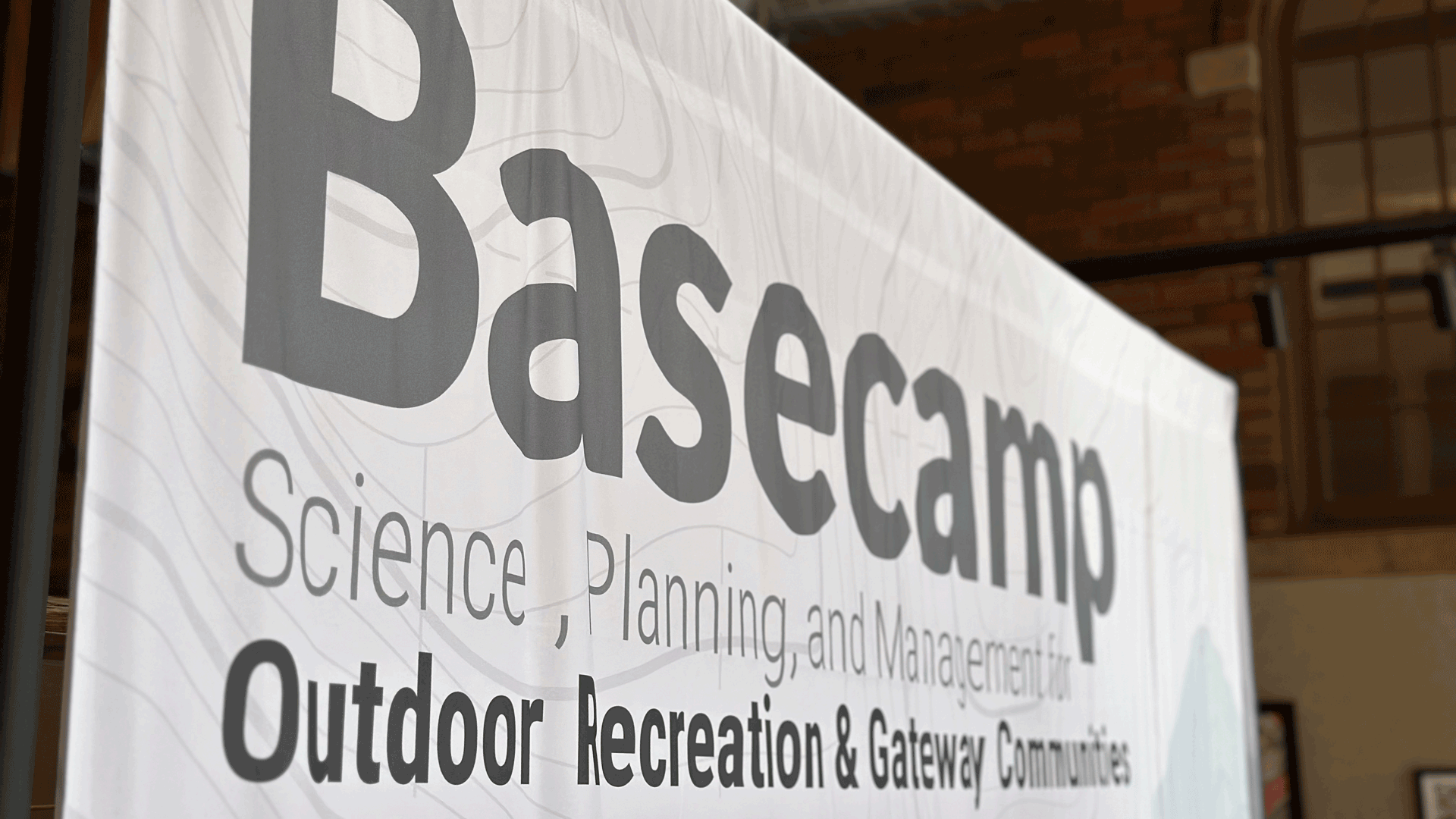 Fabric banner with the Basecamp Conference logo