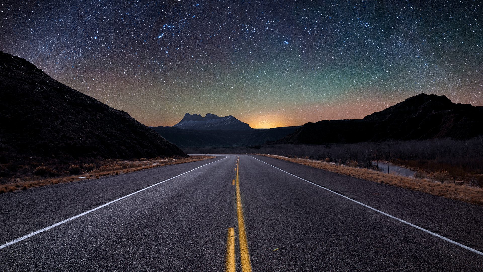 Road under a dark night sky