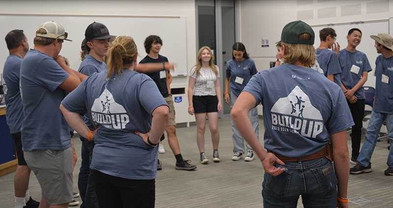 Utah youth at the annual Teen Leadership conference doing a large group team building activity