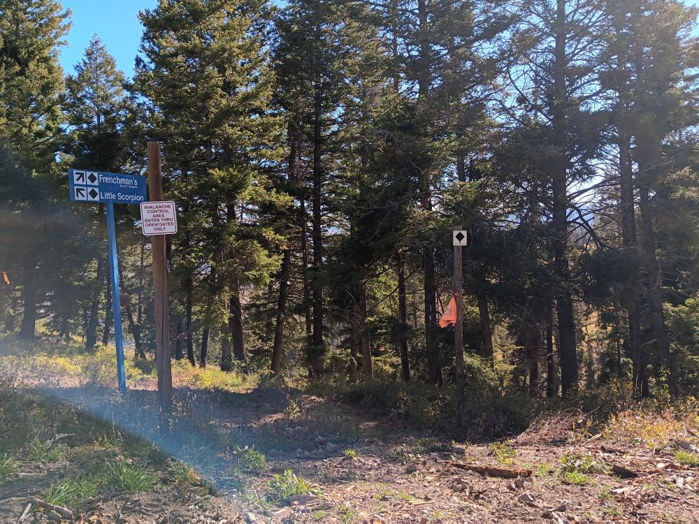 Ski signs point to ski runs named Frenchman's and Little Scorpion.