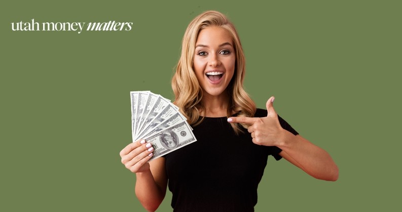 Woman holding money in one hand while pointing with the other hand.