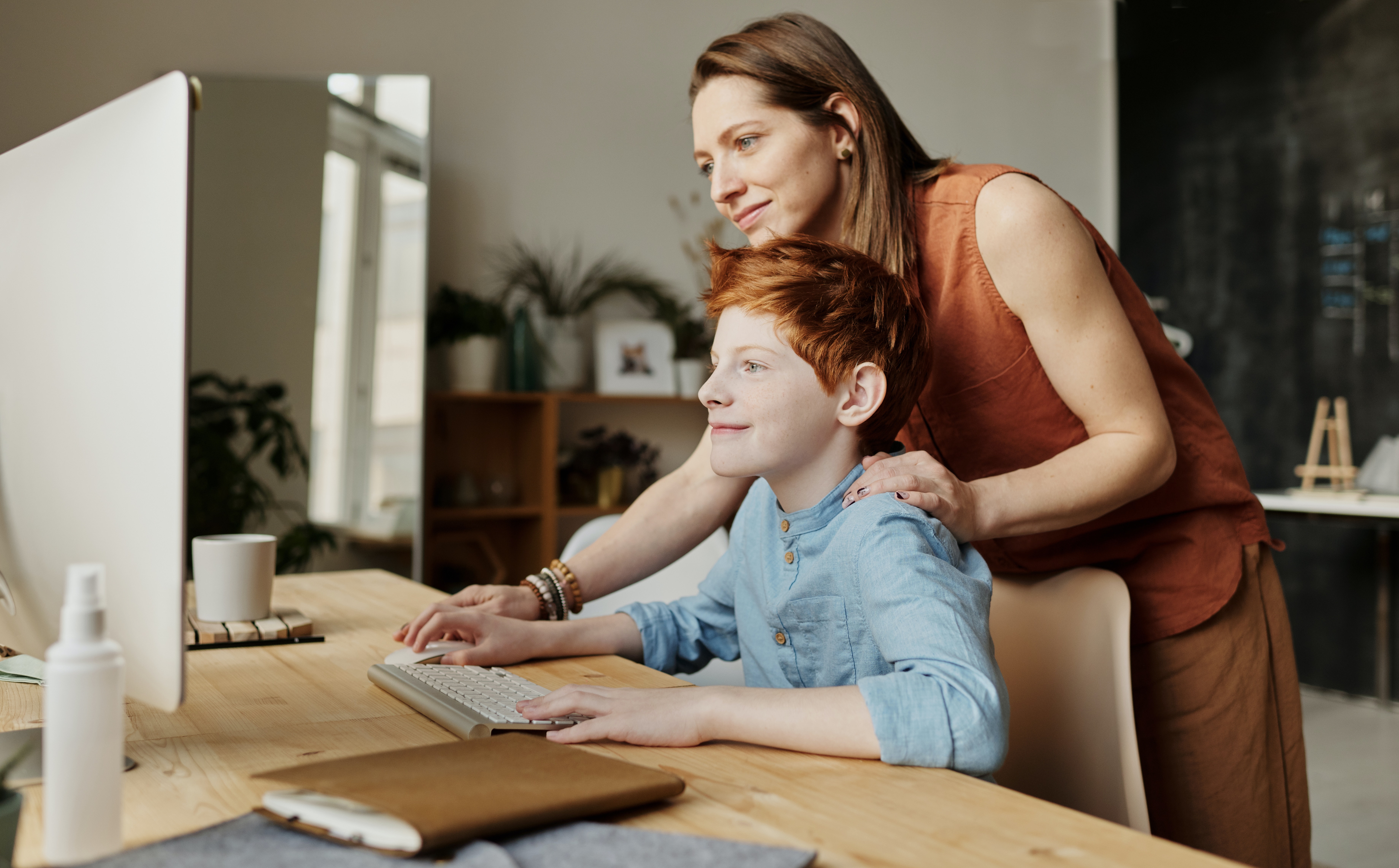 child at computer with parent