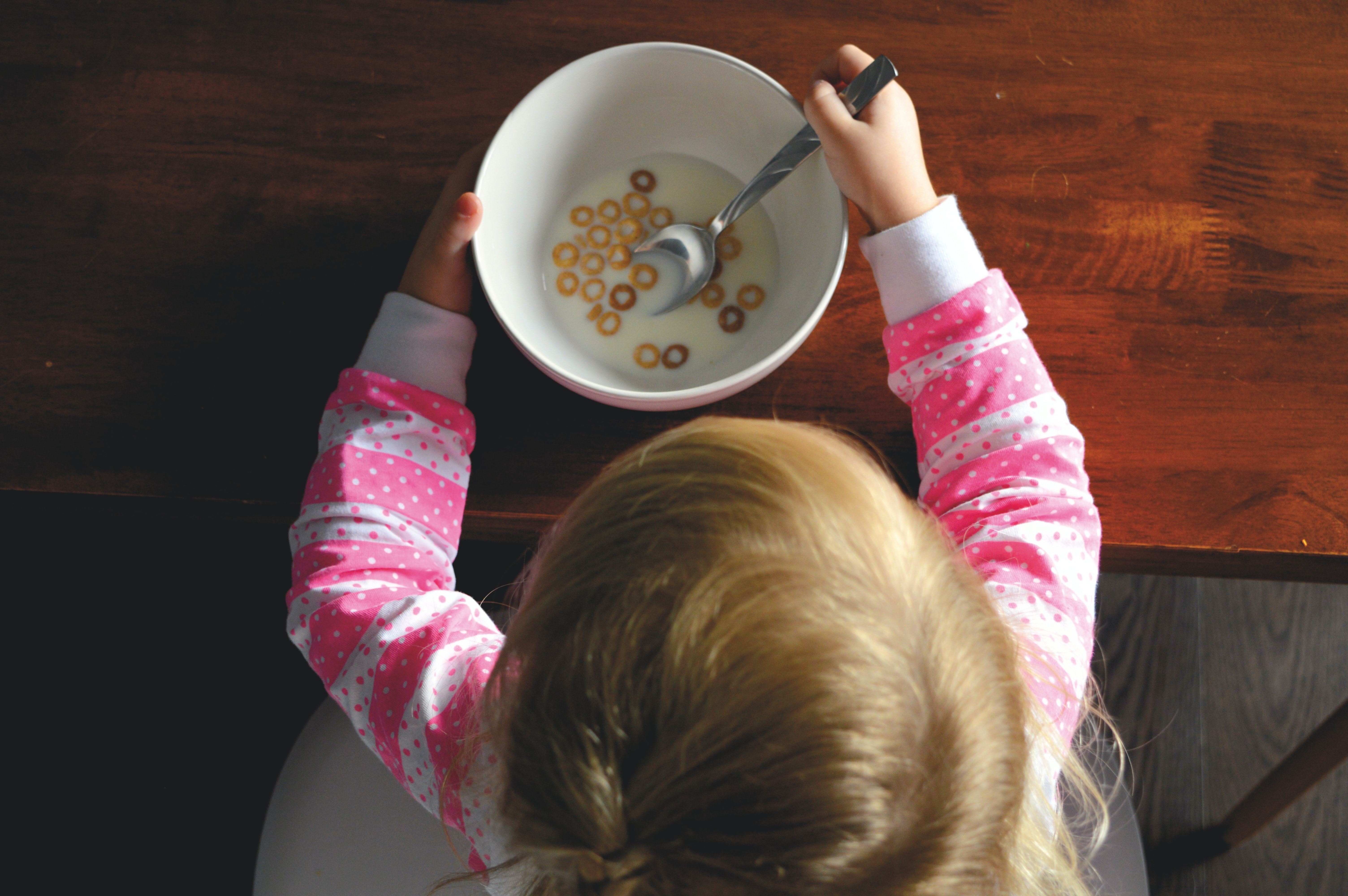 Child Enjoying Fiber-Containing Whole Wheat Cereal
