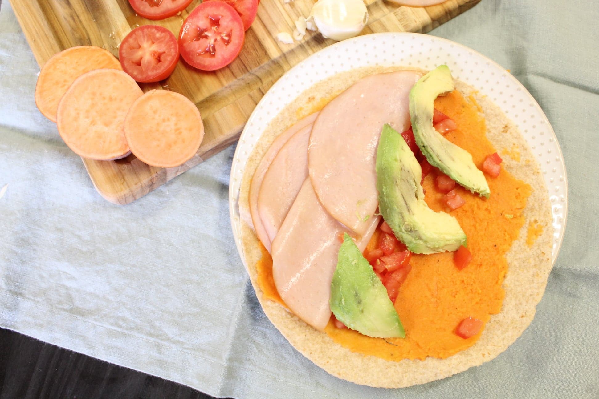 Sweet Potato wrap built with ingredients on cutting board