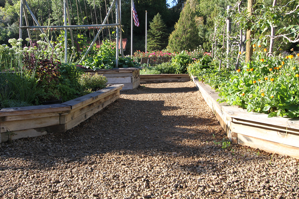 wooden planter boxes with gravel walkways between them