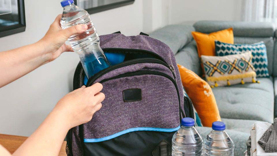 Putting water bottles in backpack