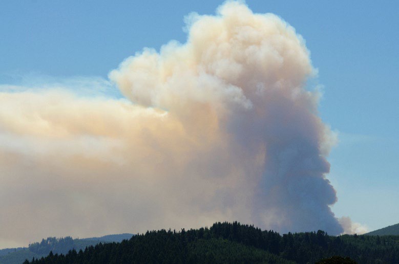 Smoke billowing out from a mountain.