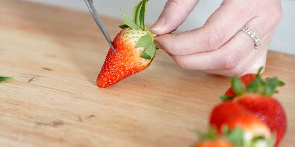 strawberry being cut