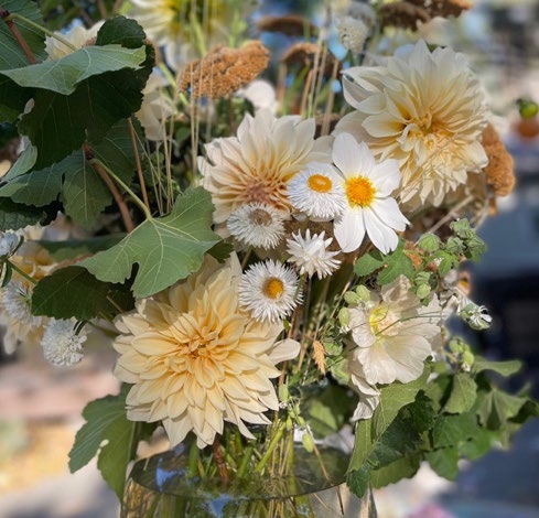 An arrangment of white flowers in a glass vase. 