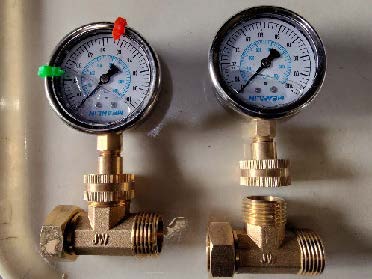 Two pressure gauges on a wall.