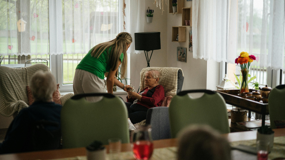 Caregiver helping elderly people in nursing home